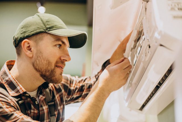 repairman-doing-air-conditioner-service-scaled